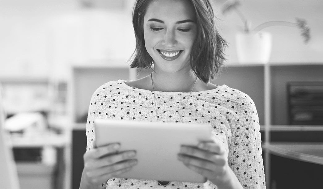 Smiling woman holding a tablet